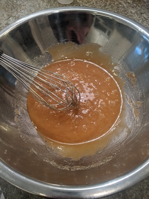 mixing sugars, eggs, brown butter